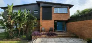 home secured with hurricane shutters as a part of a complete hurricane checklist for homeowners