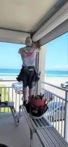 homeowner preparing property 30 days before hurricane season using a hurricane checklist
